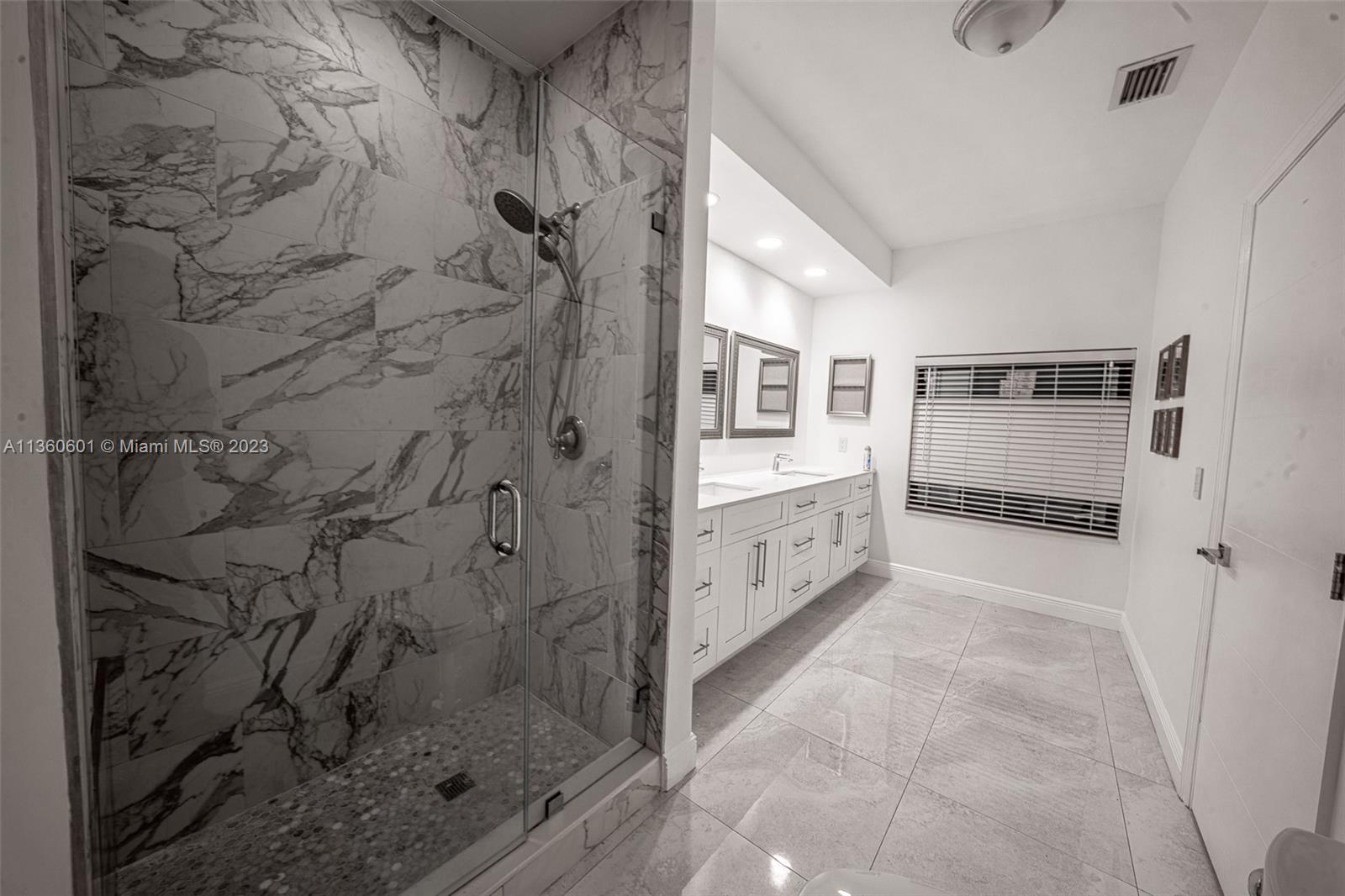 23299 Mirabella Circle North Boca Raton, FL 33433 - Photo 24 of 30 a bathroom with a shower