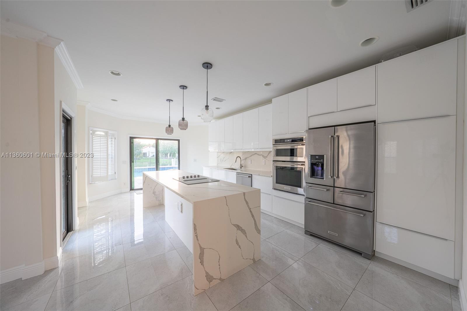 23299 Mirabella Circle North Boca Raton, FL 33433 - Photo 8 of 30 a kitchen with stainless steel appliances granite countertop a refrigerator oven a sink dishwasher and white cabinets with wooden floor
