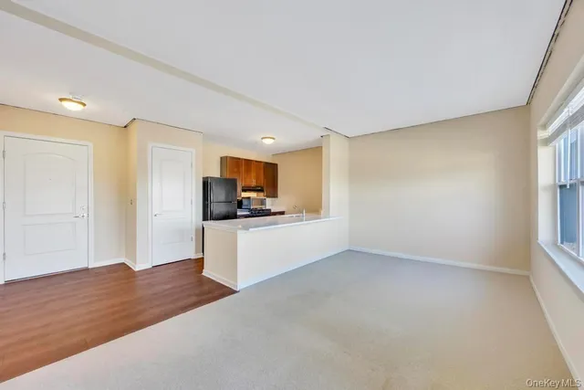 a view of kitchen with wooden floor and electronic appliances