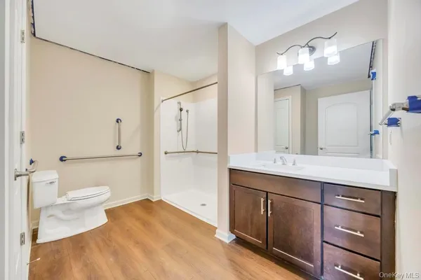 a bathroom with a sink vanity granite and toilet