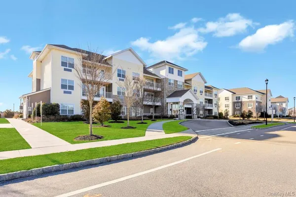 a front view of a building with yard and green space