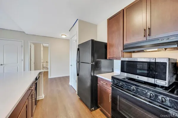 a kitchen with a refrigerator stove and cabinets