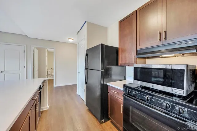 a kitchen with a refrigerator stove and cabinets