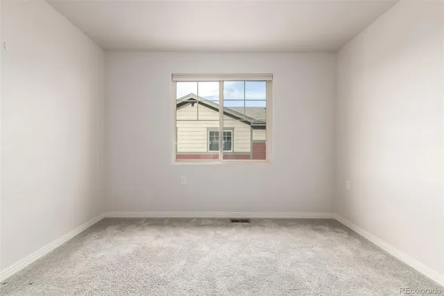 an empty room with closet area