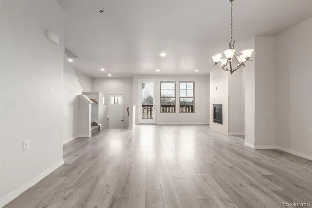 a view of a room with wooden floor and windows