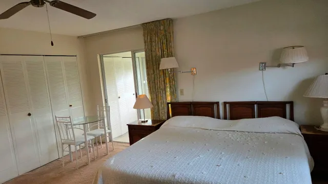 a large bedroom with a bed and a chandelier