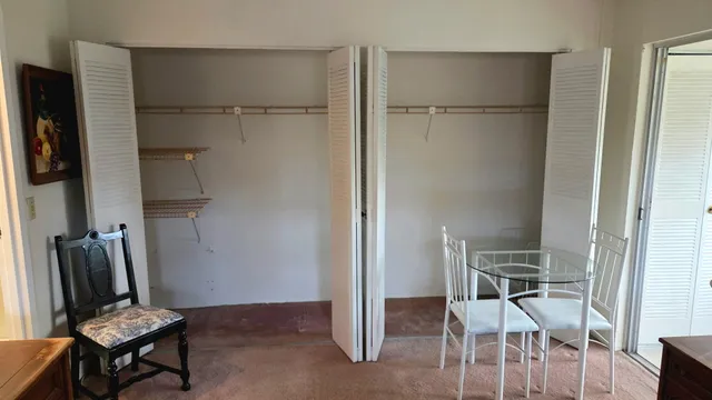 a view of kitchen with furniture and refrigerator