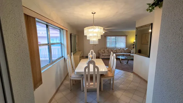 a view of a a dining room with furniture window and wooden floor
