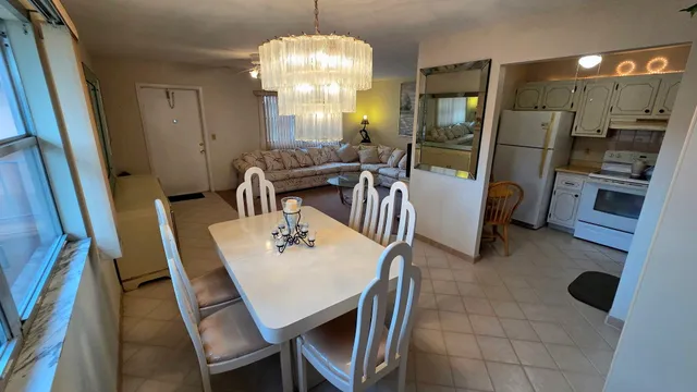 a view of a dining room with furniture and a chandelier