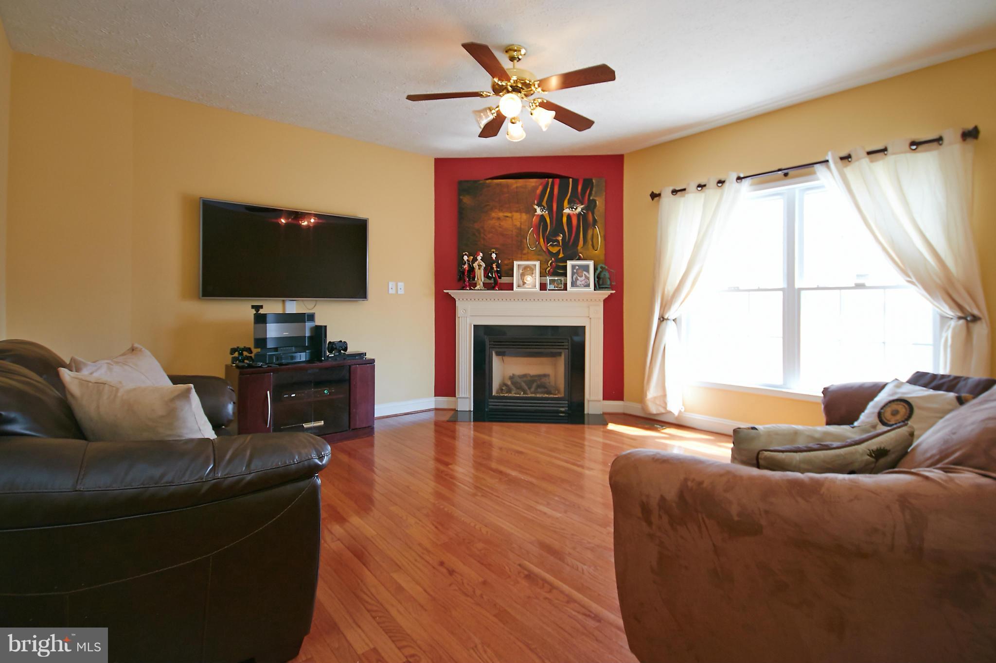 4 Yosemite Ridge Court Stafford, VA 22554 - Photo 11 of 26 a living room with furniture a fireplace and a flat screen tv