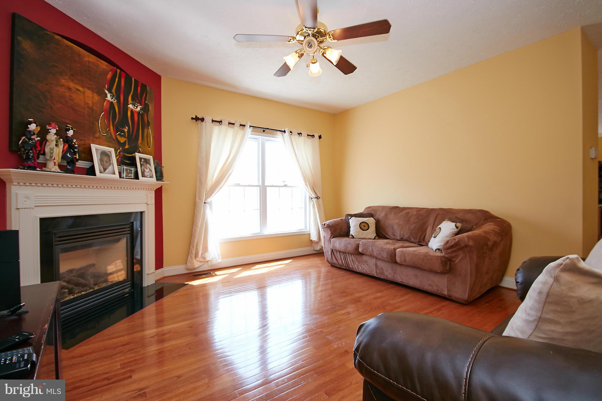 4 Yosemite Ridge Court Stafford, VA 22554 - Photo 12 of 26 a living room with furniture a fireplace and a large window