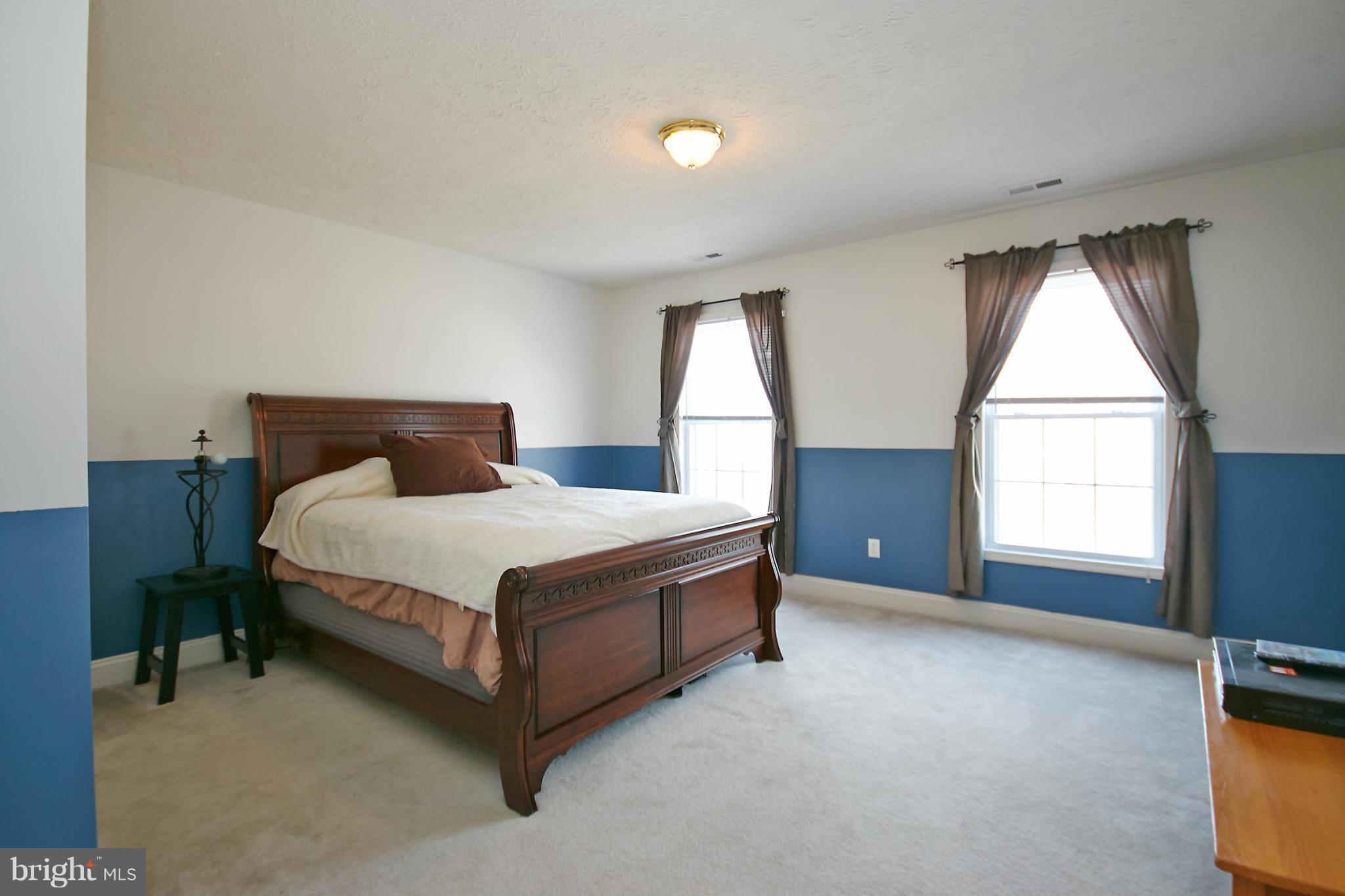 4 Yosemite Ridge Court Stafford, VA 22554 - Photo 17 of 26 a bed sitting in a room next to a window