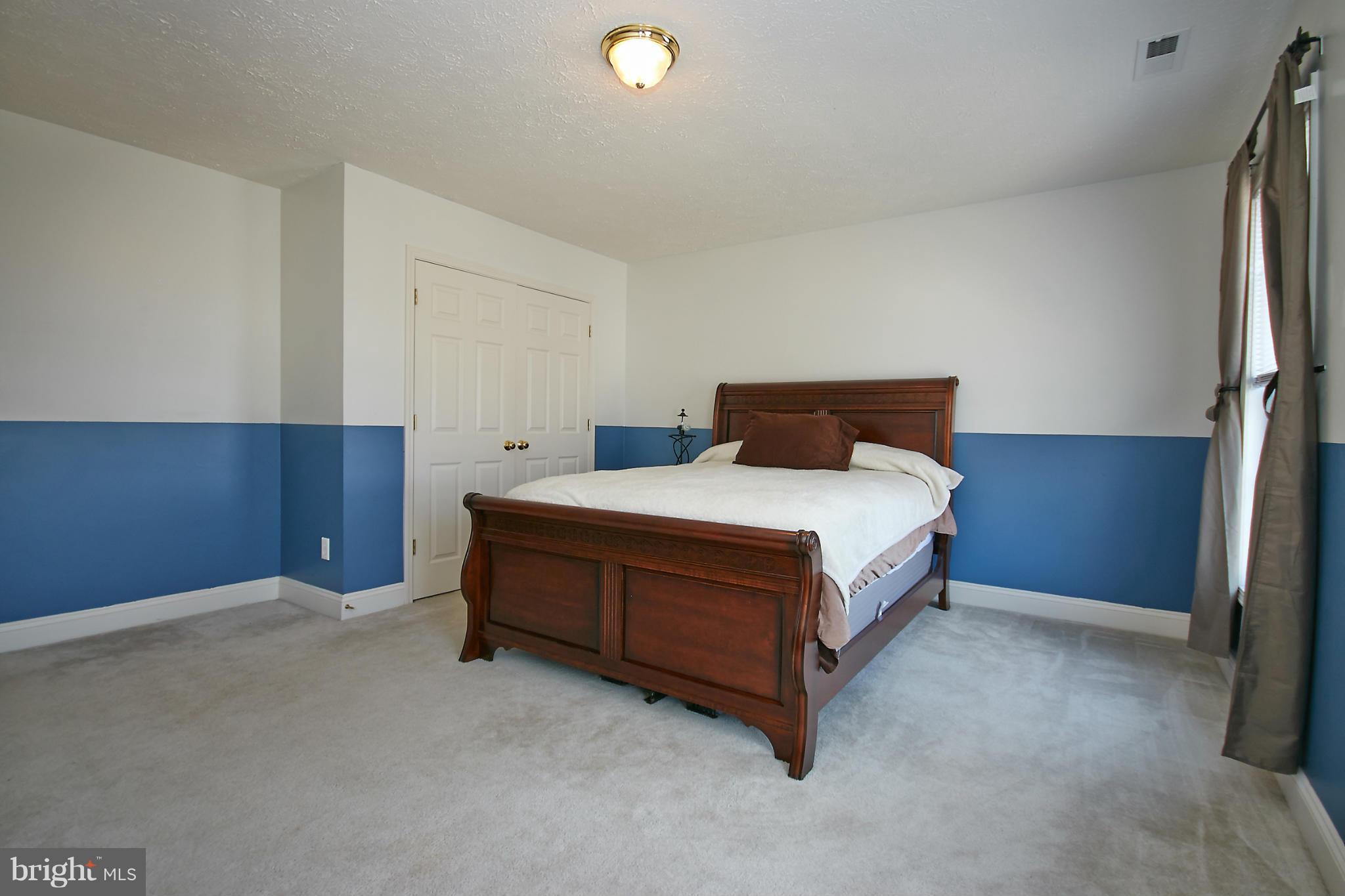 4 Yosemite Ridge Court Stafford, VA 22554 - Photo 18 of 26 a bedroom with a bed and a night stand