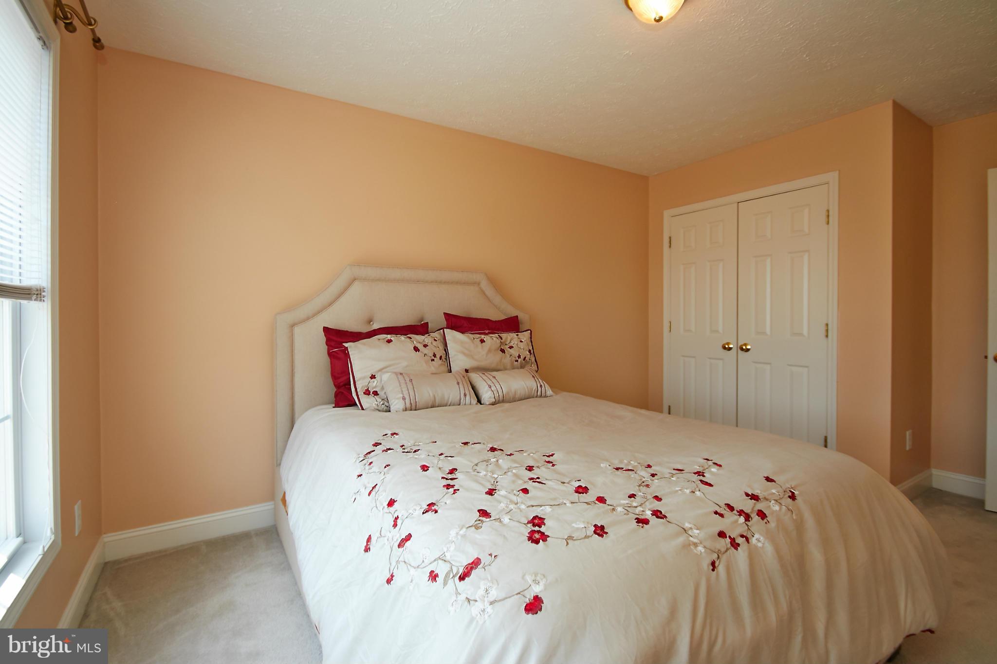 4 Yosemite Ridge Court Stafford, VA 22554 - Photo 20 of 26 a bedroom with a bed and a painting on the wall