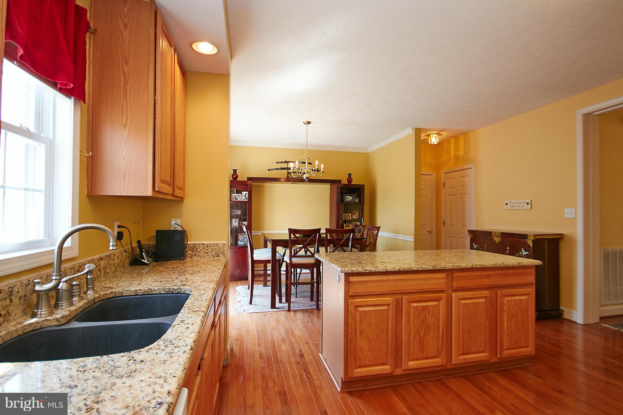 4 Yosemite Ridge Court Stafford, VA 22554 - Photo 8 of 26 a kitchen with a sink and wooden cabinets