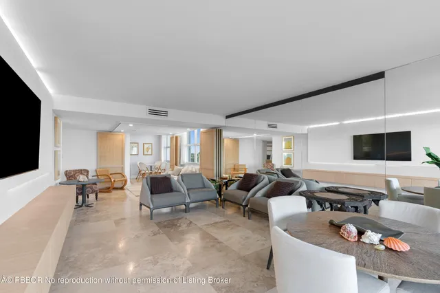 a living room with furniture chess board and a large window