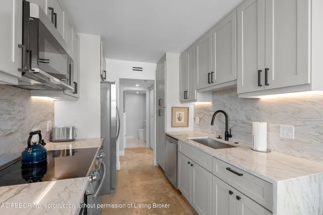 a bedroom with a bed a couch and a flat screen tv