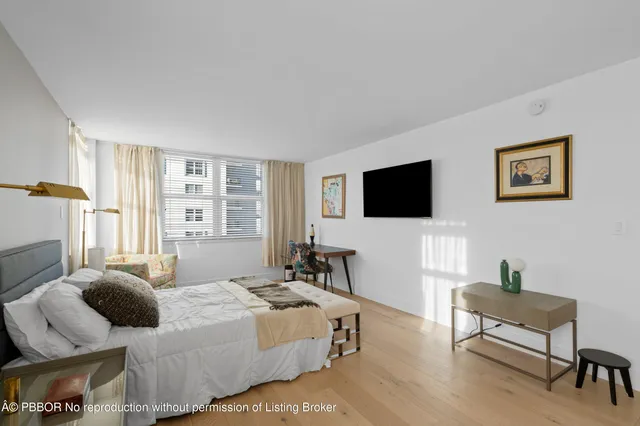 a bathroom with a granite countertop sink a toilet a shower and a mirror