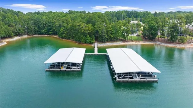 an aerial view of a house with a garden and lake view