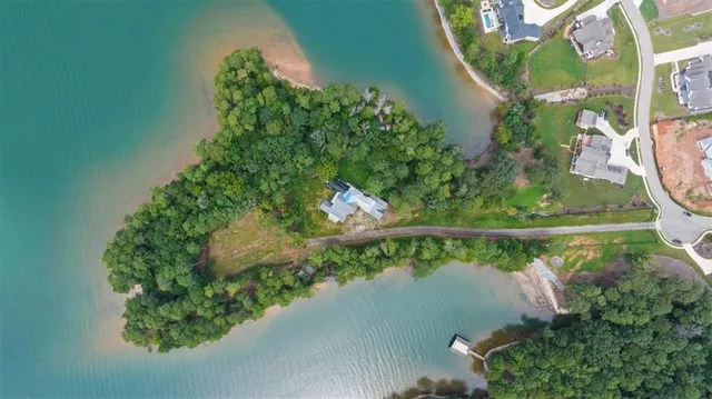 a view of a lake with a yard and potted plants