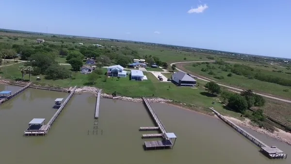 an aerial view of a swimming pool with a yard