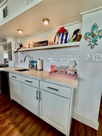 a living room with lots of furniture wooden floor and a table