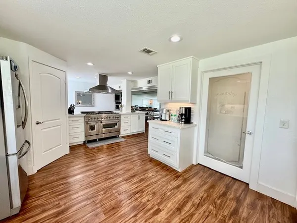a kitchen with stainless steel appliances and white cabinets