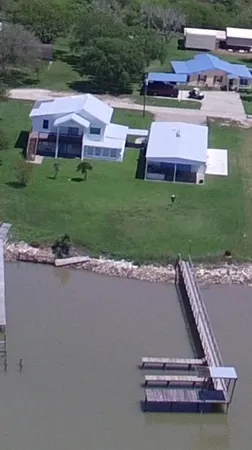 a view of a swimming pool and lounge chairs in back yard