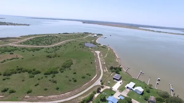 an aerial view of a golf course with a car park