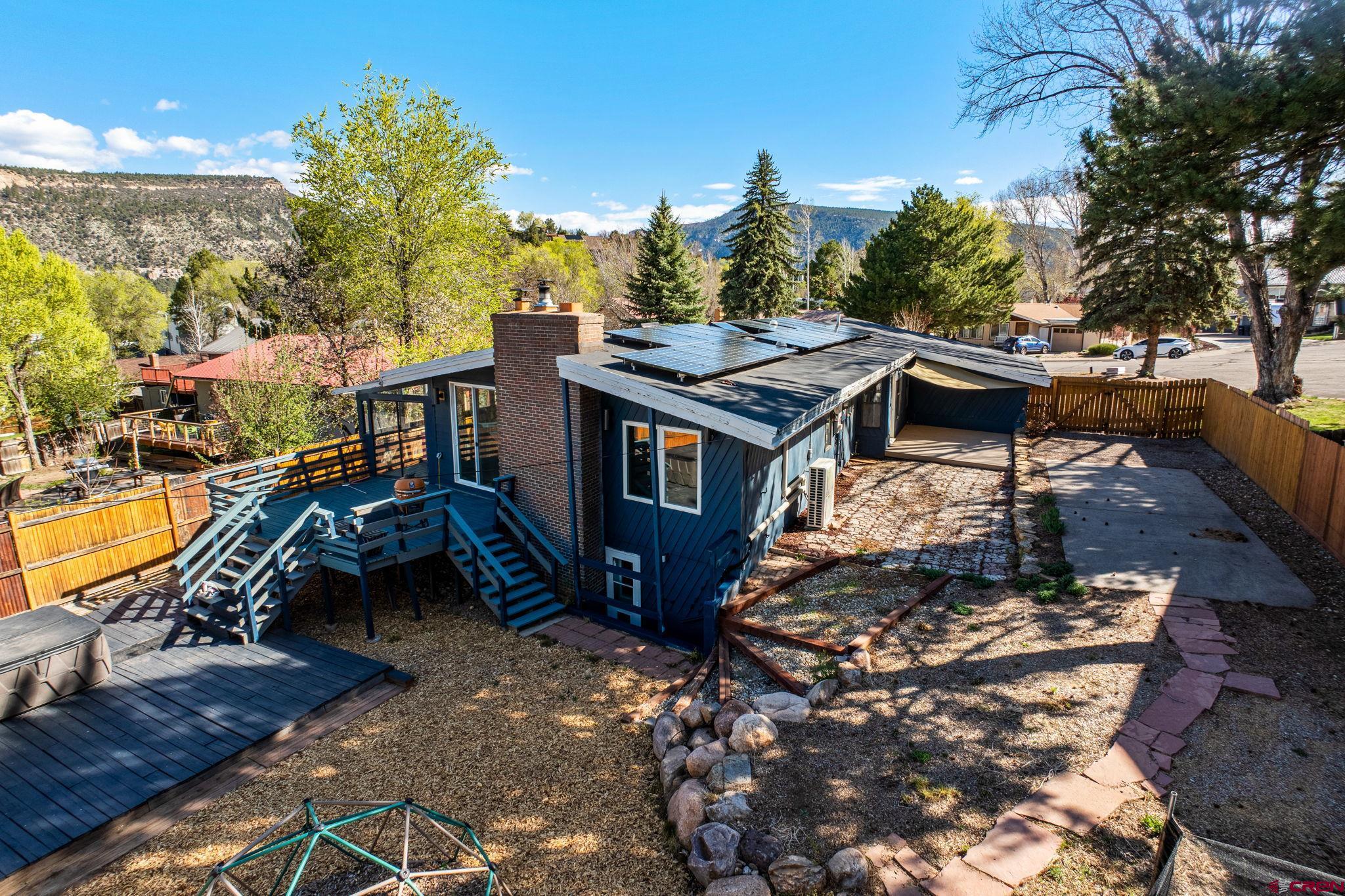 a view of a house with pool and sitting area