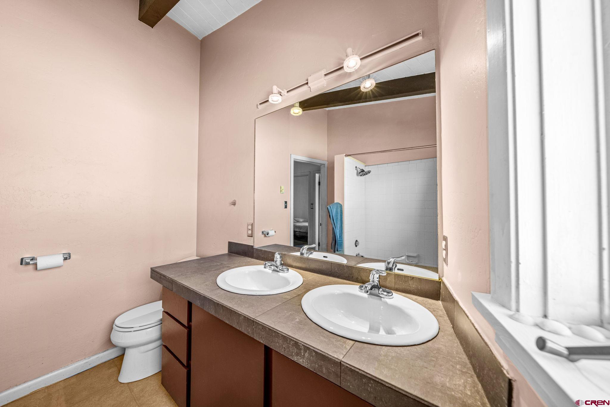 17 Maple Drive Durango, CO 81301 - Photo 12 of 44 a bathroom with a granite countertop sink toilet and a mirror