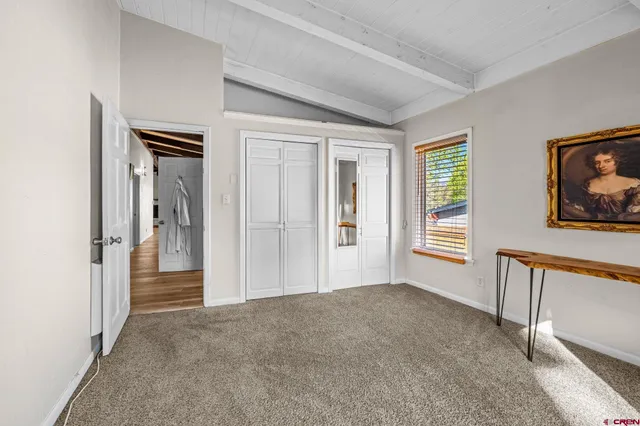 a view of a livingroom with wooden floor and windows