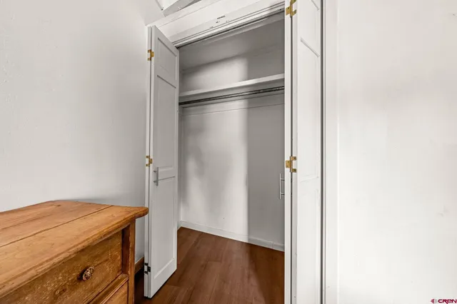 a bedroom with a bed and utility room with windows