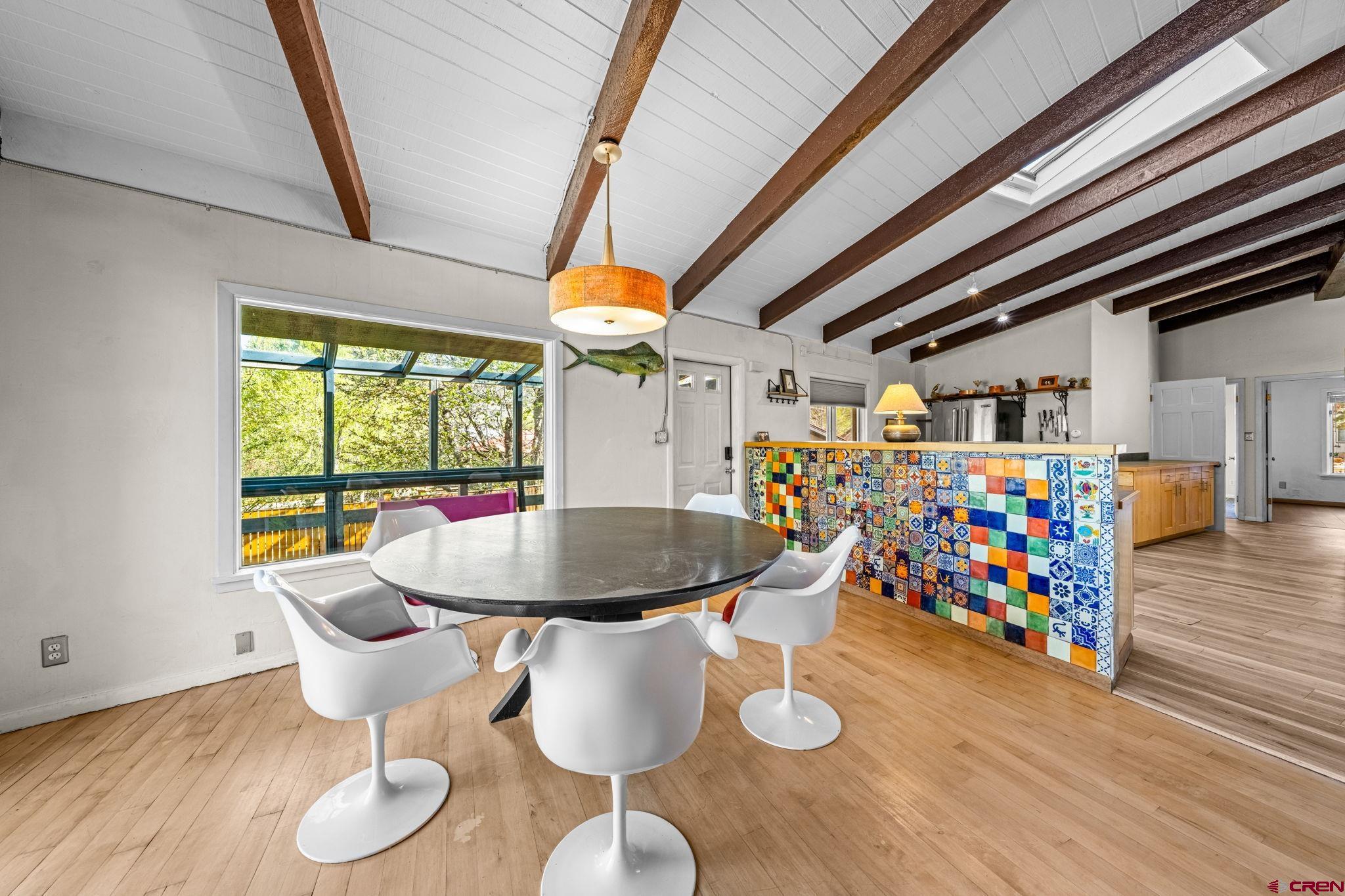 17 Maple Drive Durango, CO 81301 - Photo 2 of 44 a dining room with furniture a rug a potted plant and wooden floor
