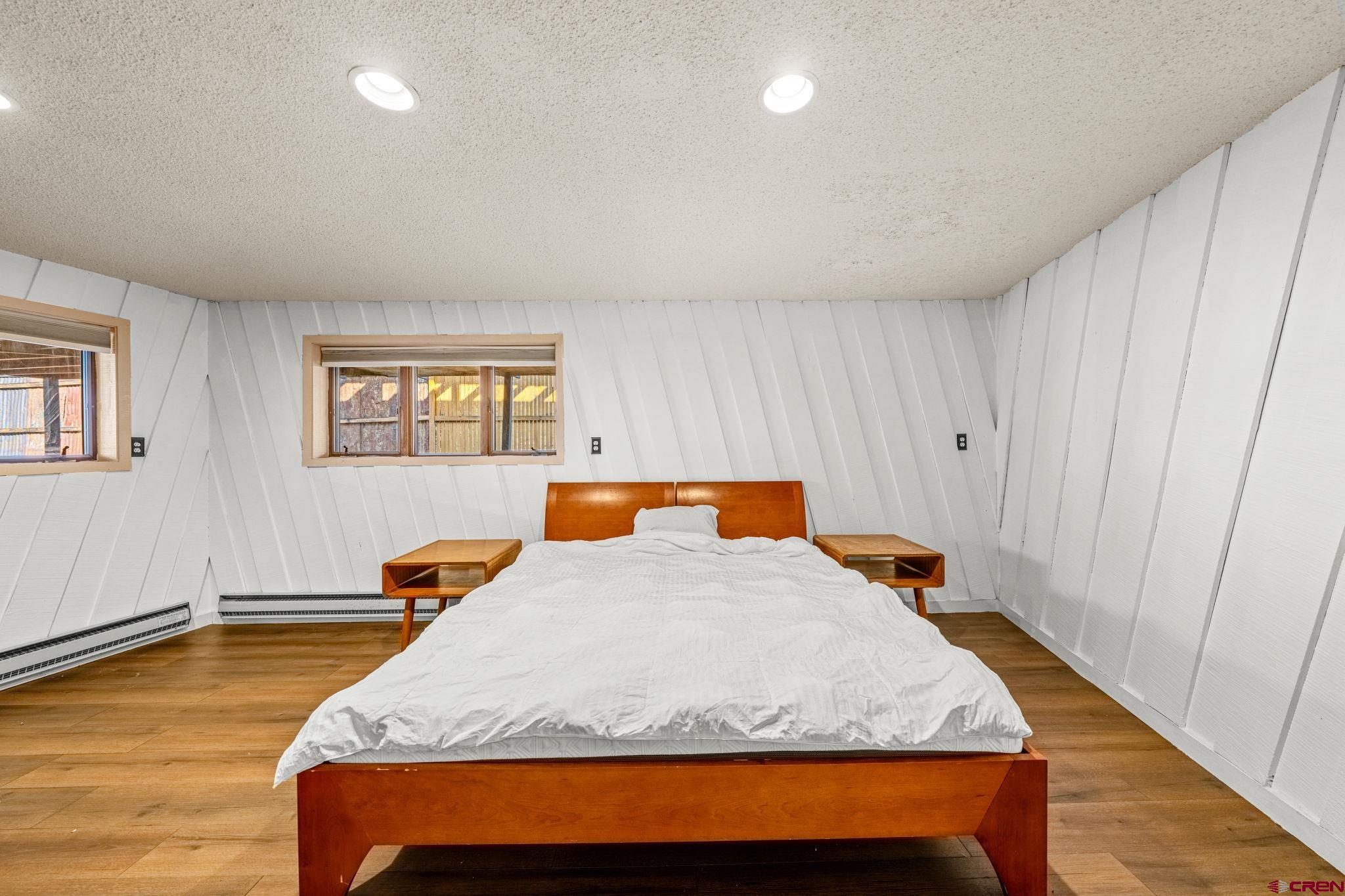 17 Maple Drive Durango, CO 81301 - Photo 25 of 44 a bedroom with a bed and wooden floor