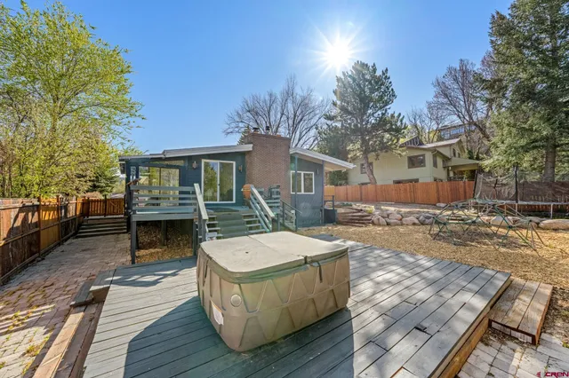 a view of a small yard with wooden fence