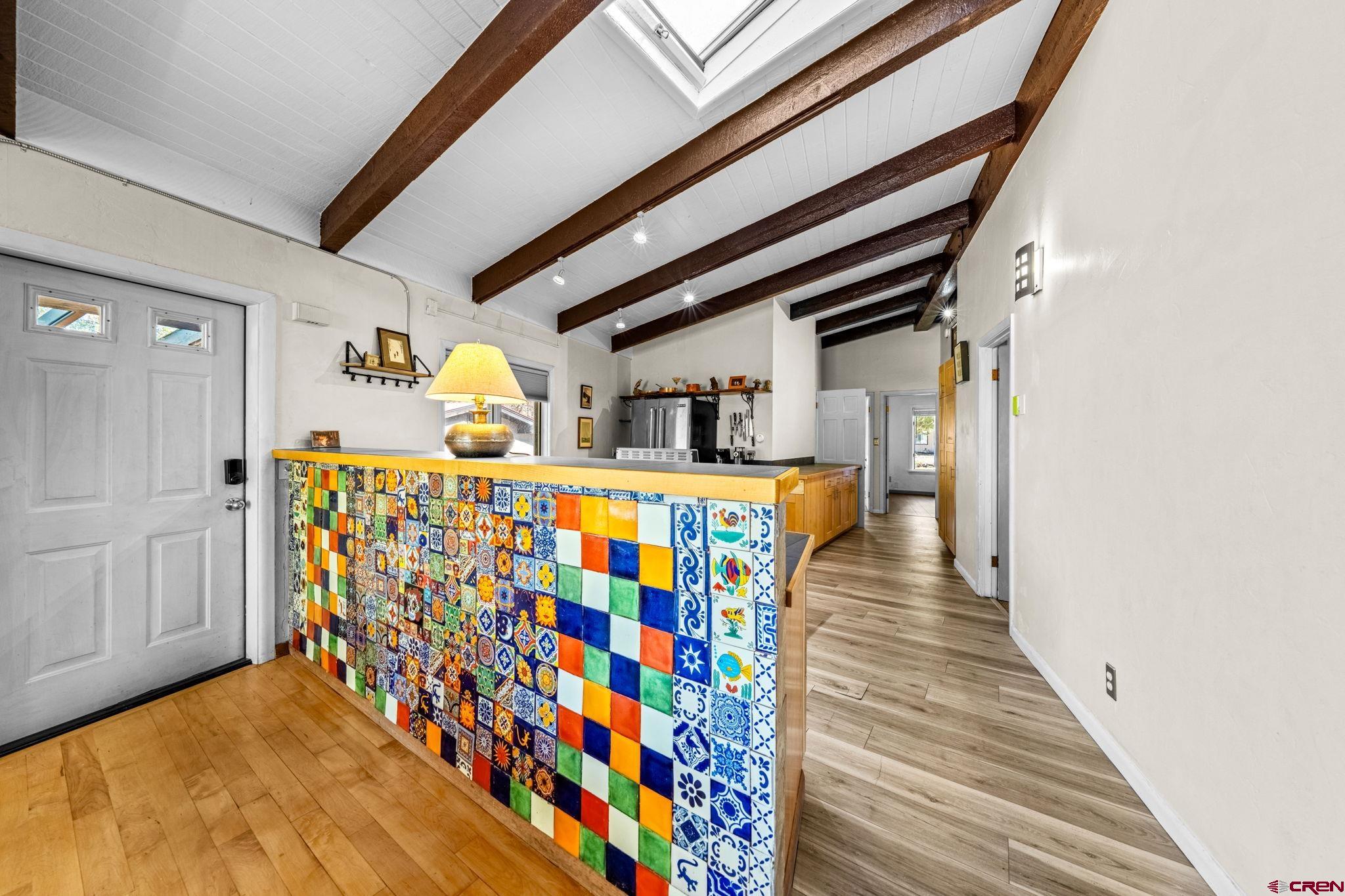 17 Maple Drive Durango, CO 81301 - Photo 4 of 44 a hallway with painting on the wall and a potted plant