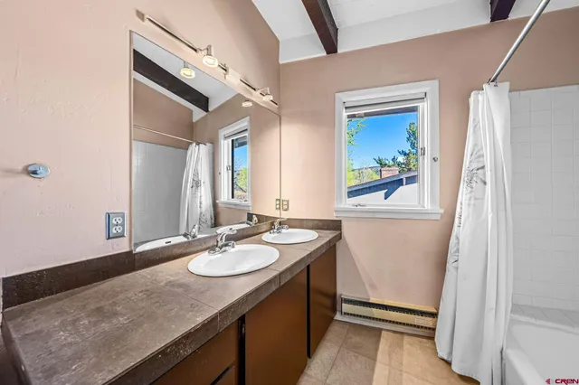 a bathroom with a shower curtain and a bathtub