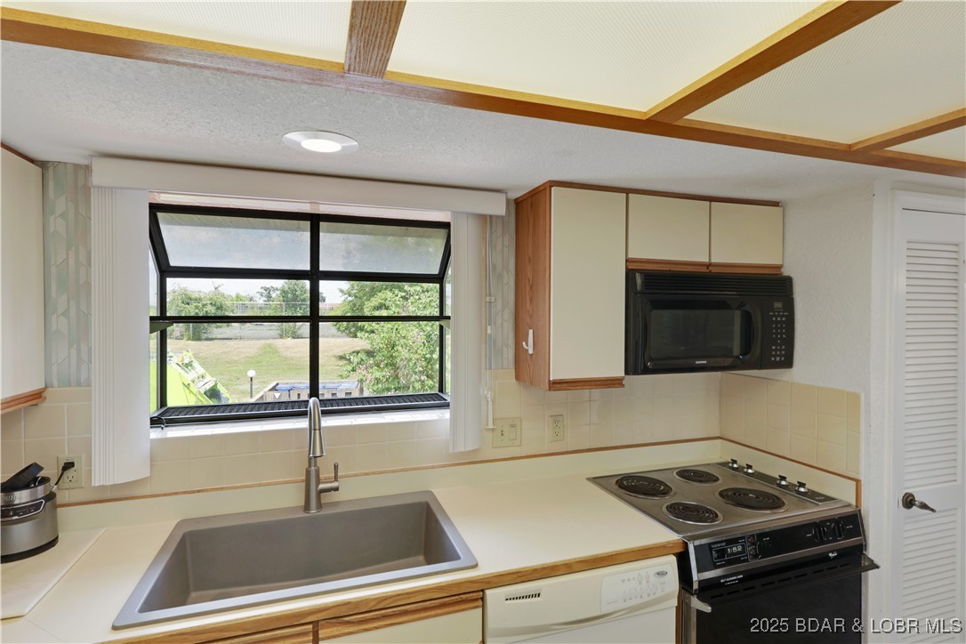 24 East Casa Del Rio, Unit 693 Lake Ozark, MO 65049 - Photo 13 of 30 View of kitchen and roadside window.