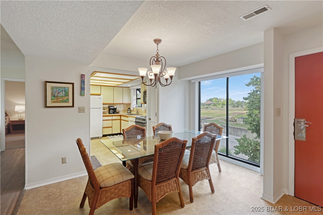 24 East Casa Del Rio, Unit 693 Lake Ozark, MO 65049 - Photo 7 of 30 Dining area with laminate flooring.