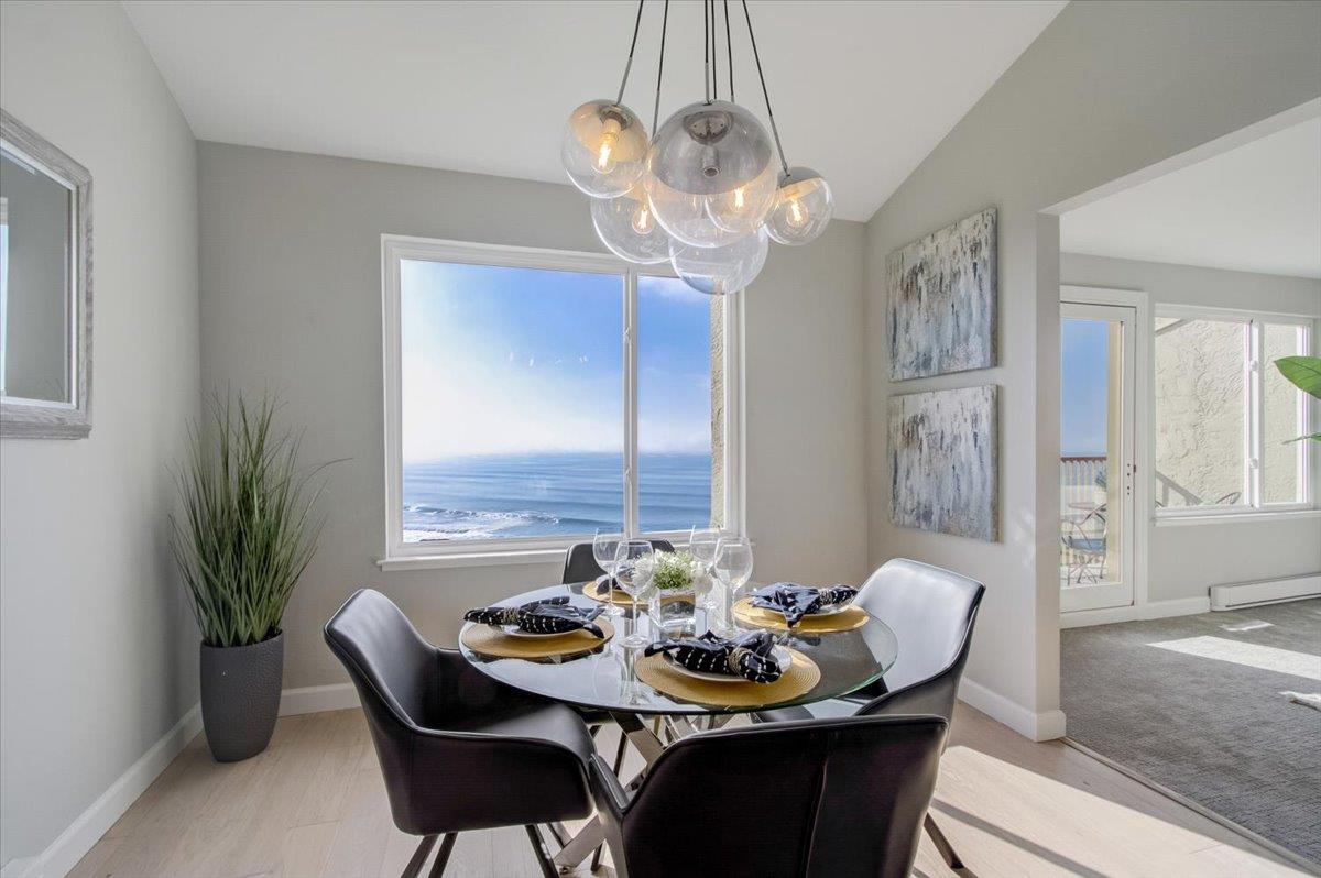 5007 Palmetto Avenue, Unit 42 Pacifica, CA 94044 - Photo 12 of 53 a view of a dining room with furniture a chandelier and wooden floor