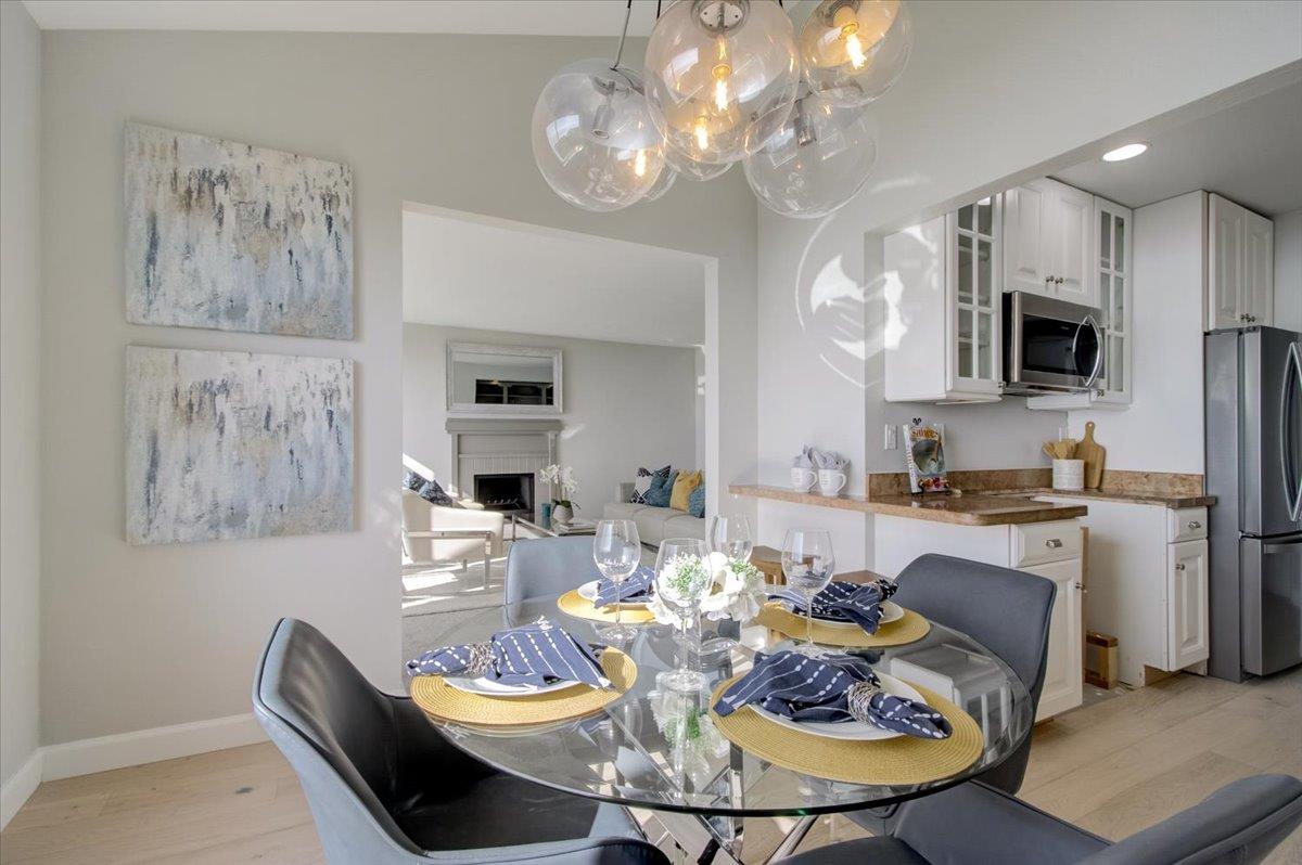 5007 Palmetto Avenue, Unit 42 Pacifica, CA 94044 - Photo 13 of 53 a view of a dining room with furniture a kitchen and chandelier