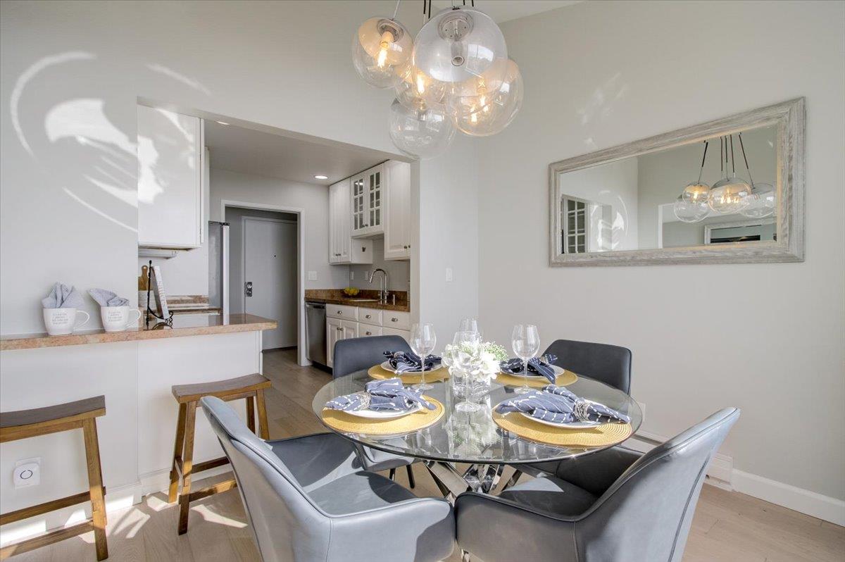 5007 Palmetto Avenue, Unit 42 Pacifica, CA 94044 - Photo 14 of 53 a view of a dining room with furniture and chandelier