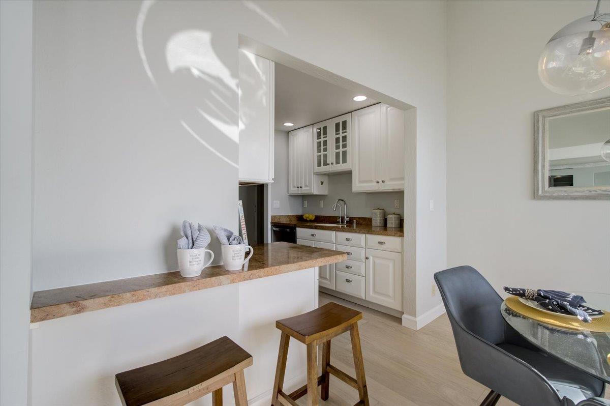 5007 Palmetto Avenue, Unit 42 Pacifica, CA 94044 - Photo 17 of 53 a kitchen with stainless steel appliances granite countertop a sink and a refrigerator