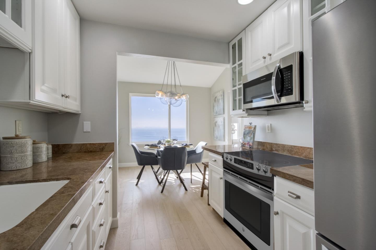 5007 Palmetto Avenue, Unit 42 Pacifica, CA 94044 - Photo 19 of 53 a kitchen with stainless steel appliances granite countertop a stove a sink and a microwave