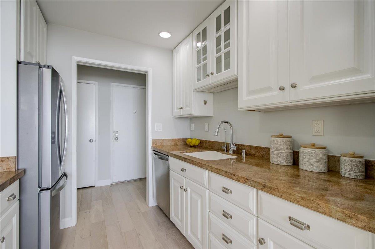 5007 Palmetto Avenue, Unit 42 Pacifica, CA 94044 - Photo 21 of 53 a kitchen with stainless steel appliances granite countertop a sink stove and cabinets