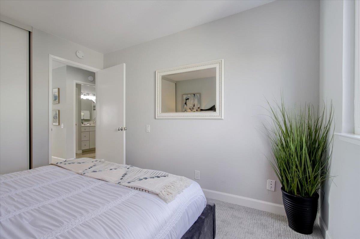 5007 Palmetto Avenue, Unit 42 Pacifica, CA 94044 - Photo 23 of 53 a bedroom with a bed and a potted plant