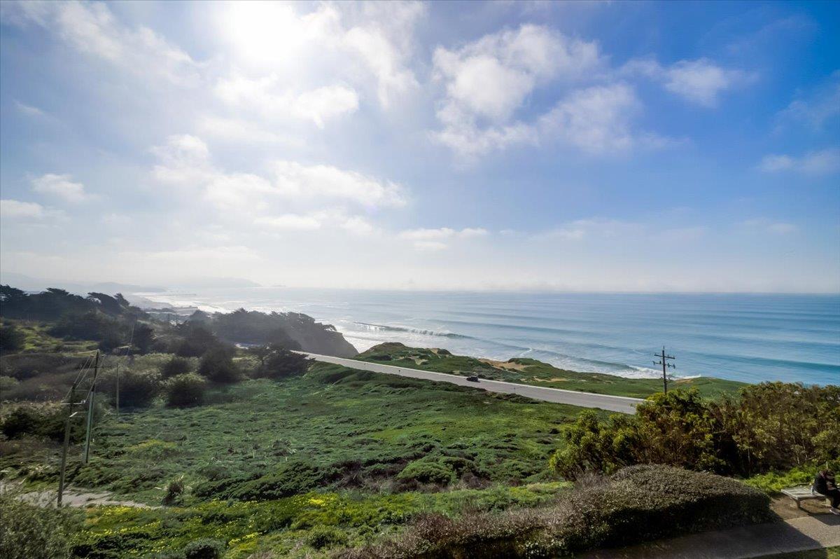 5007 Palmetto Avenue, Unit 42 Pacifica, CA 94044 - Photo 34 of 53 a view of a field with an ocean and trees