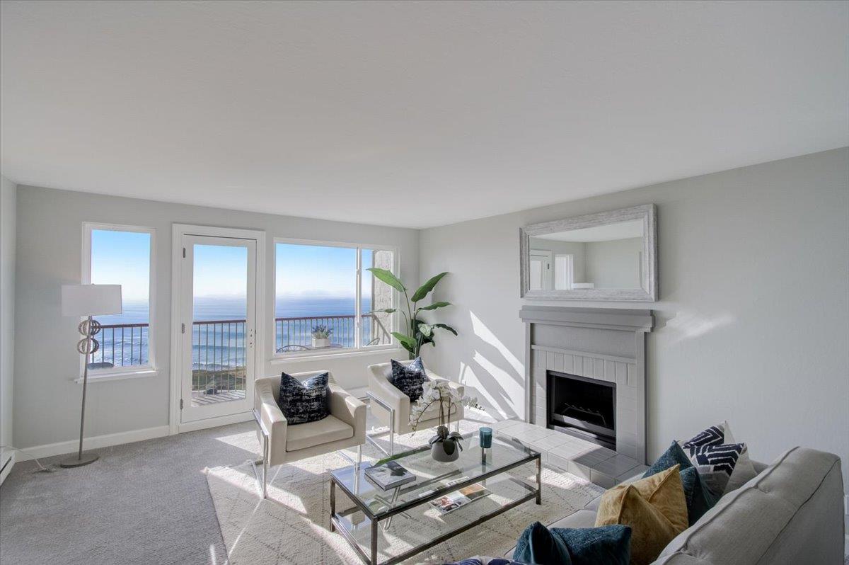 5007 Palmetto Avenue, Unit 42 Pacifica, CA 94044 - Photo 9 of 53 a living room with furniture a fireplace and a potted plant