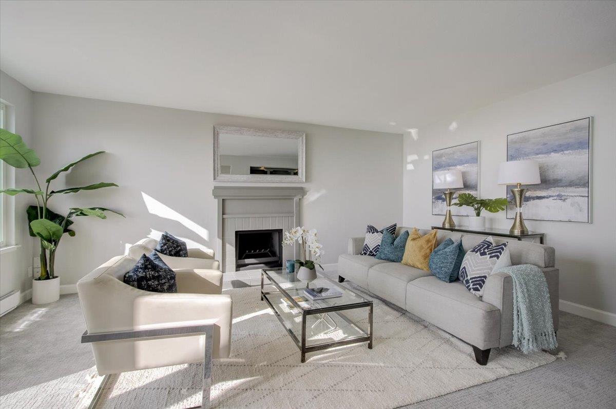 5007 Palmetto Avenue, Unit 42 Pacifica, CA 94044 - Photo 10 of 53 a living room with furniture a fireplace and a potted plant